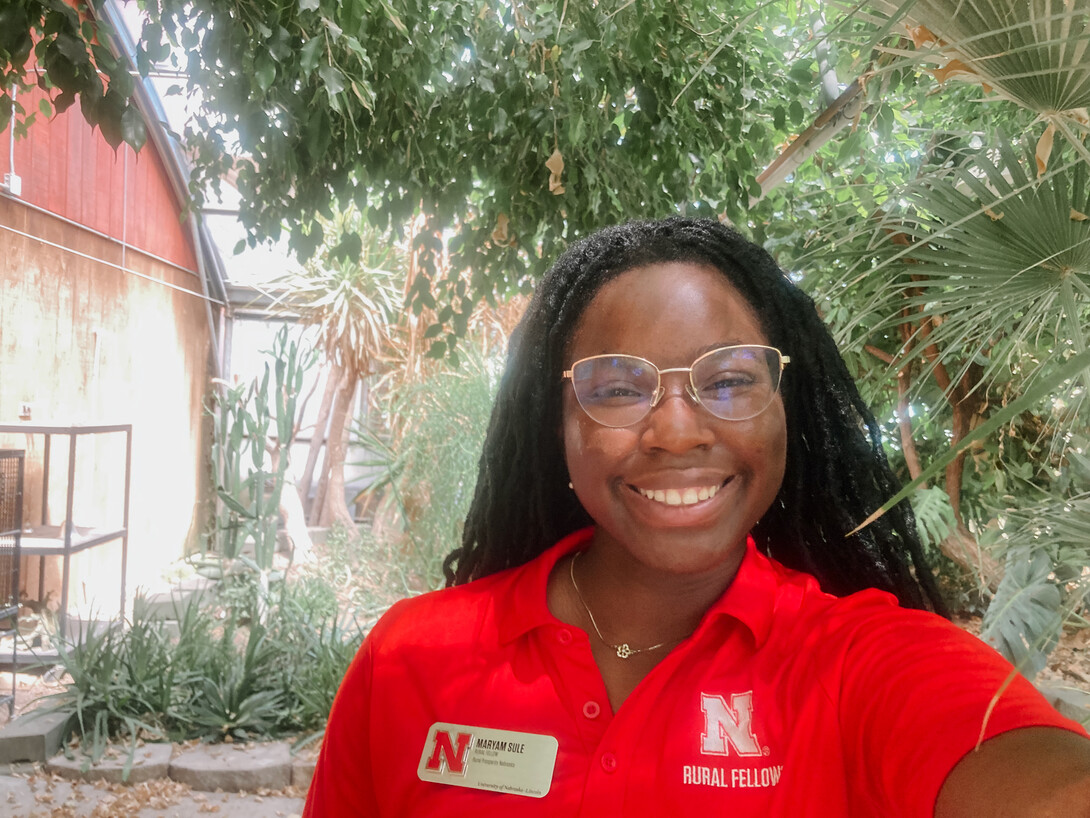 Sule poses in her Rural Fellows shirt and name tag. 