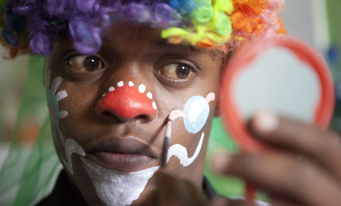 Birhanu Taddese applies clown make up before working at the pediatric ward at the Black Lion Hospital in Addis Ababa, Ethiopia. Photos like this one were taken by 12 UNL photojournalism students who spent three weeks in Ethiopia developing content for a new depth report.