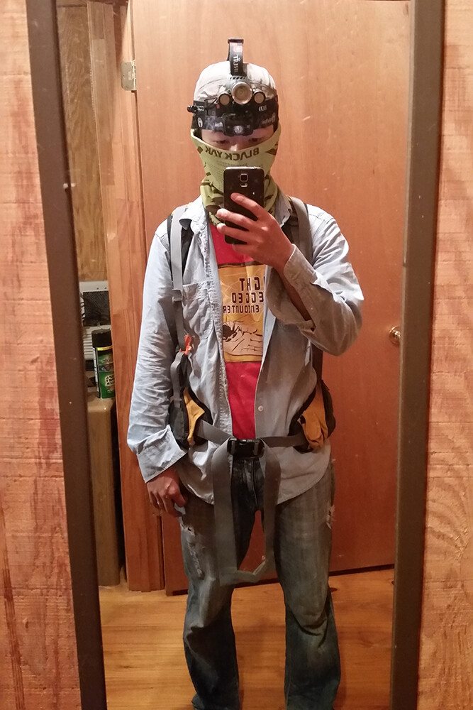 Noori Choi donning a headlamp, backpack and other field gear