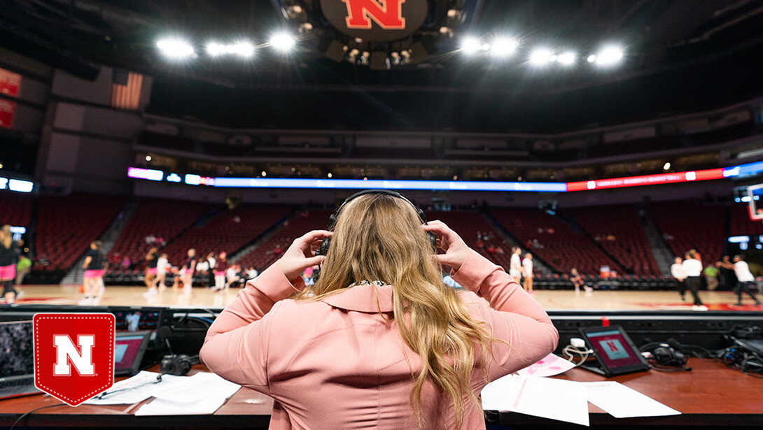 A sports media student prepares to call the play-by-play of a Husker basketball game in Pinnacle Bank Arena.