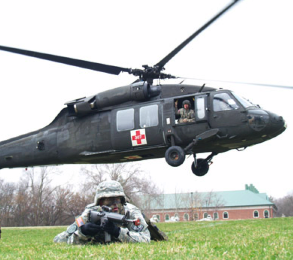 UNL ROTC cadets form a perimeter as a helicopter takes off during a training mission on the grounds of Doane College in Crete.