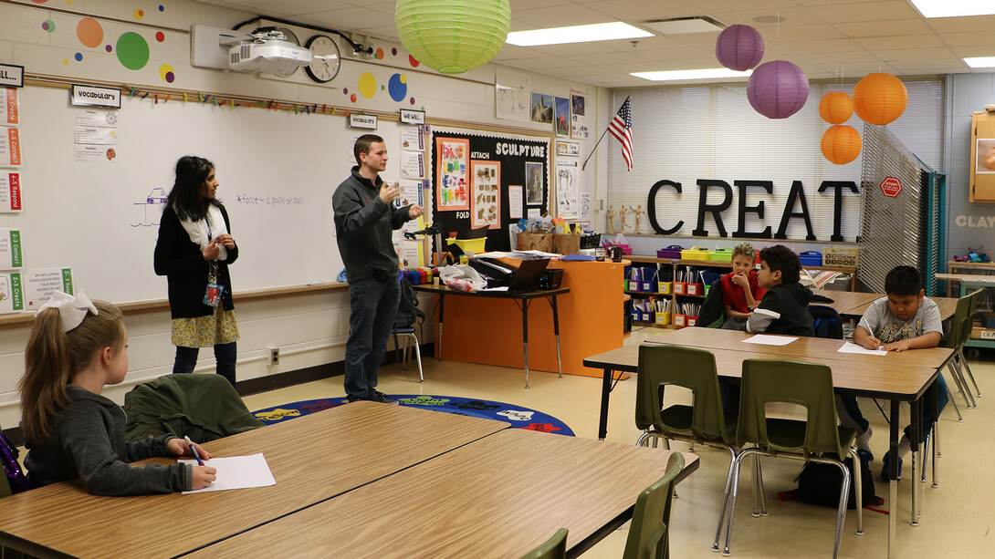 Riha Karney (standing, left) is among the more than 60 University Honors Program students who continue to develop and offer after-school curricula online after schools shutdown in response to COVID-19.