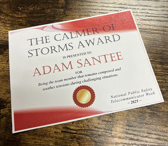 A small paper award, "The Calmer of Storms" sits on Adam Santee's desk.