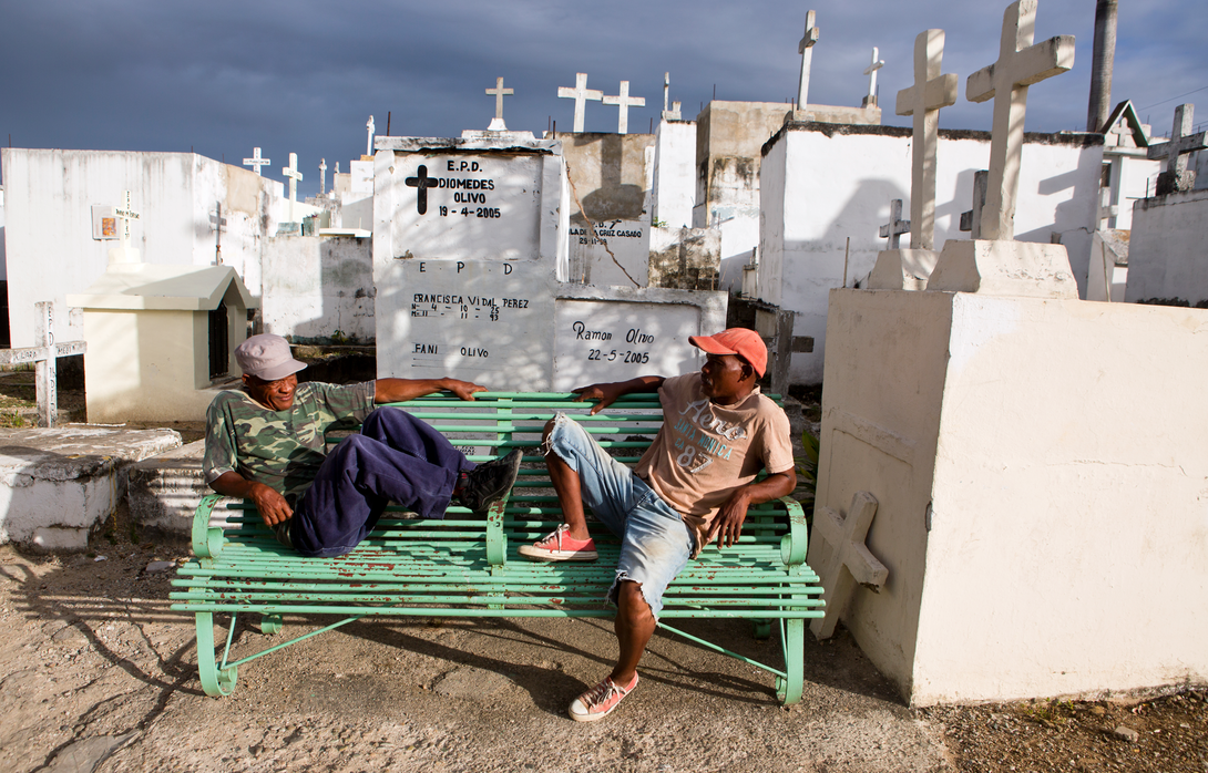 Two Dominicans sit in the public cemetery in Cristo Rey, Santo Domingo. Read more in a story by Joseph Moore at http://go.unl.edu/xww9.