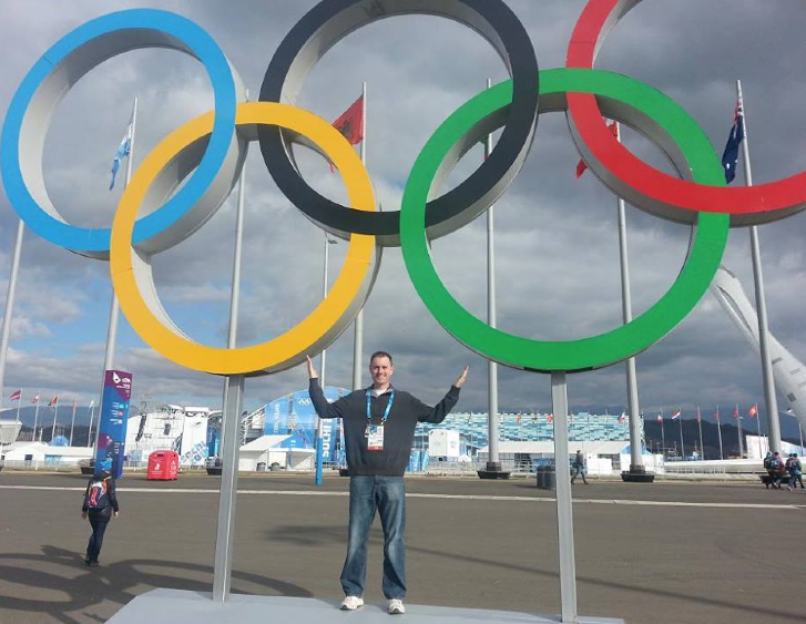 Kevin Kugler poses with the Olympic rings in Sochi, Russia.