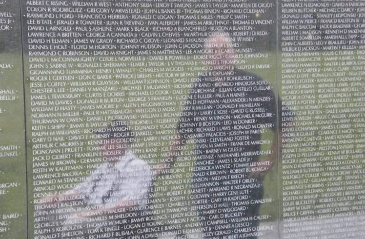 Veterans reflected on a wall at the Vietnam Veterans Memorial in Washington, D.C.