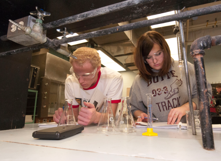 Chemistry students work shoulder to shoulder in the cramped lab space in Hamilton Hall. The space was designed in the 1970s.