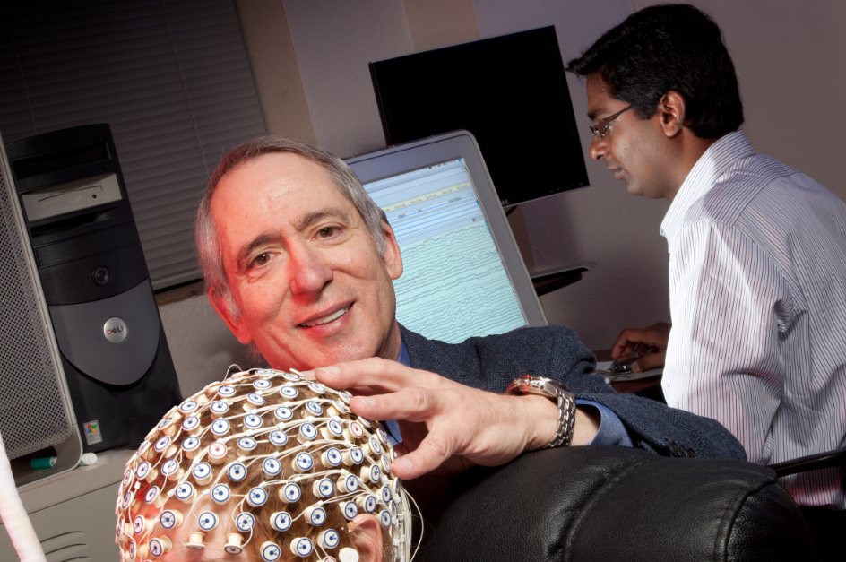 Dennis Molfese (center), director of the Center for Brain, Biology and Behavior, works with undergraduate Katherine Meidlinger (in cap) and post-doctorate research associate Srinivas Kota. Photo by Craig Chandler, University Communications.