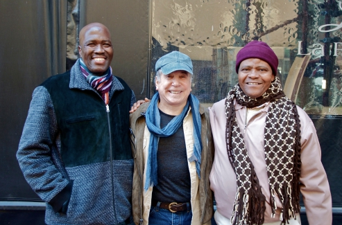 Ladysmith Black Mambazo performers Albert Mazibuko (left) and Joseph Shabalala (right) with Paul Simon. 