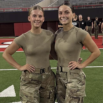 Two ROTC cadets pose on the field after the stair climb.
