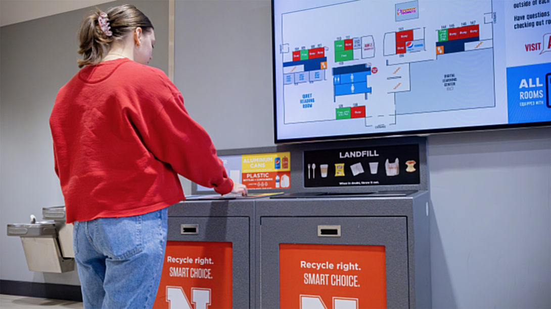 Person using a recycling station.