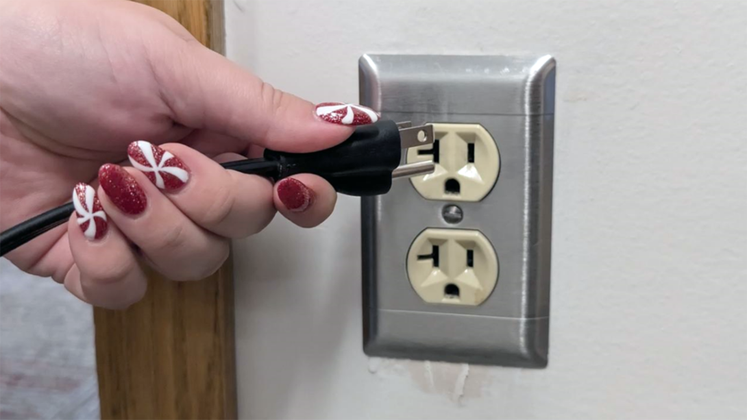 Person unplugging an electronic device.