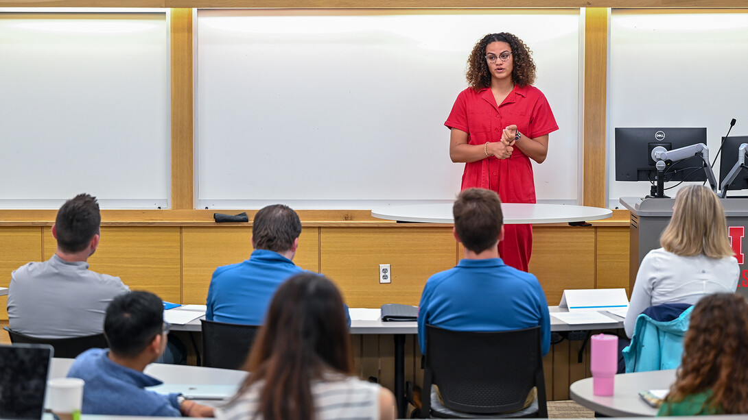 Student speaking at front of a classroom