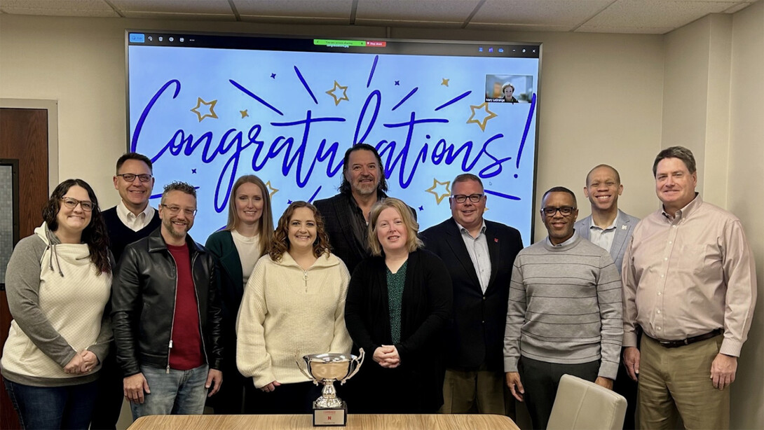 Members of the Business and Finance team pose with Lawrence Chatters and the Chancellor's Cup after earning the Large Office Division in the 2024-25 United Way campaign.