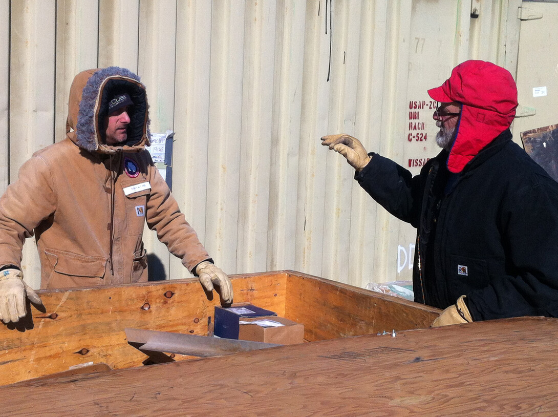 Daren Blythe (left) and Dennis Duling at McMurdo Station, unpacking part of ANDRILL's roving hot-water drill.
