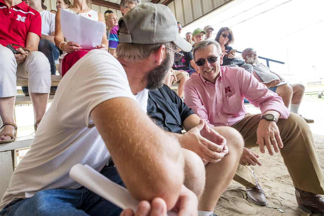 .Spectators at the Fillmore County Fair talk with Chancellor Ronnie Green during his June 13 trip to three counties in southeastern Nebraska.