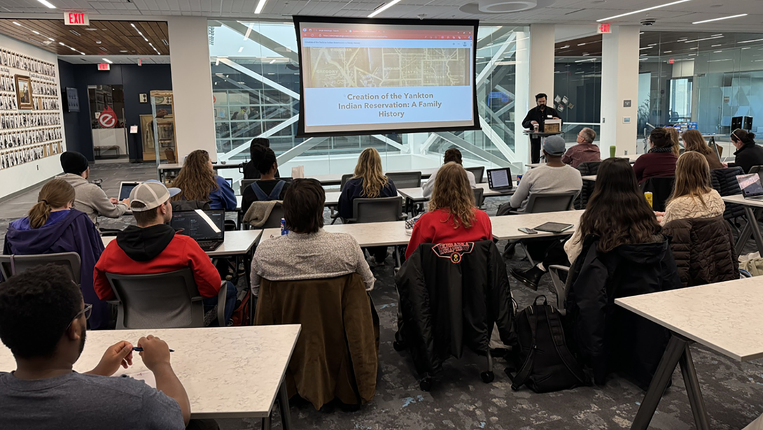 Audience members gather to see presentations of the GIS Day maps competition.