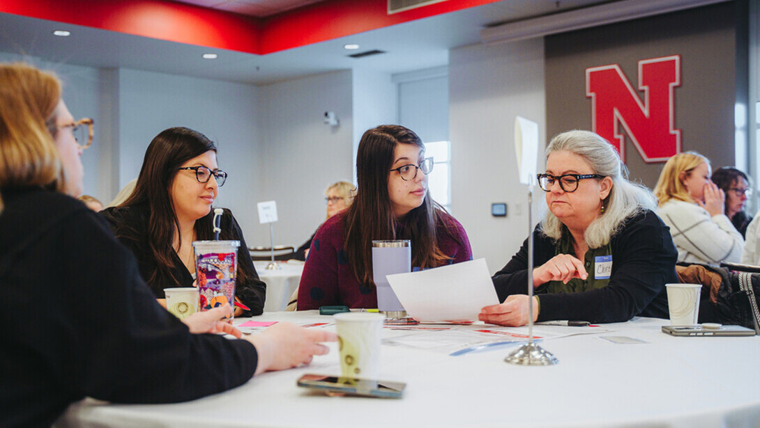 Participants discuss a workshop activity at a table in Nebraska Union.