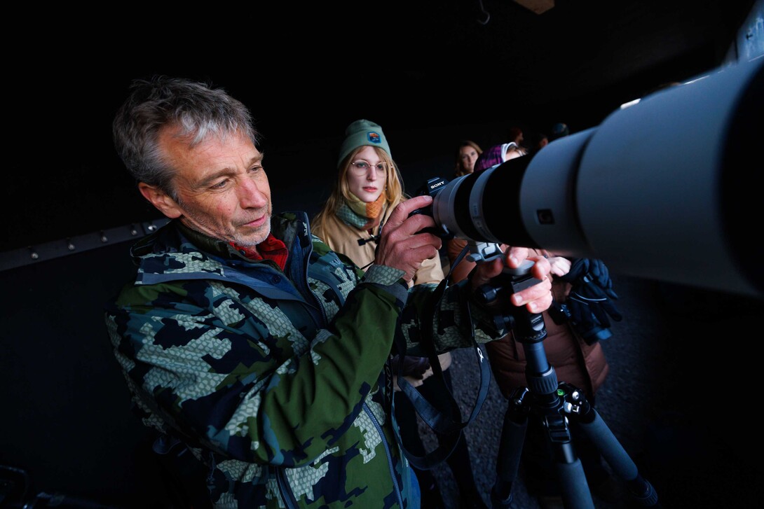  Michael Forsberg, left, Research Assistant Professor in the School of Natural Resources, helps Lilliane Roberts, a senior Fisheries and Wildlife major, set up their camera as they prepare to watch Sandhill Cranes arrive on the Platte River. 