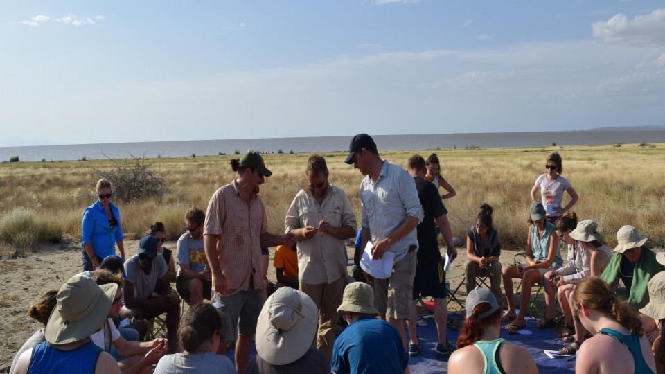 Matthew Douglass (center) and colleagues instruct students from U.S. and African universities in stone artifact identification at the Koobi Fora Base Camp.