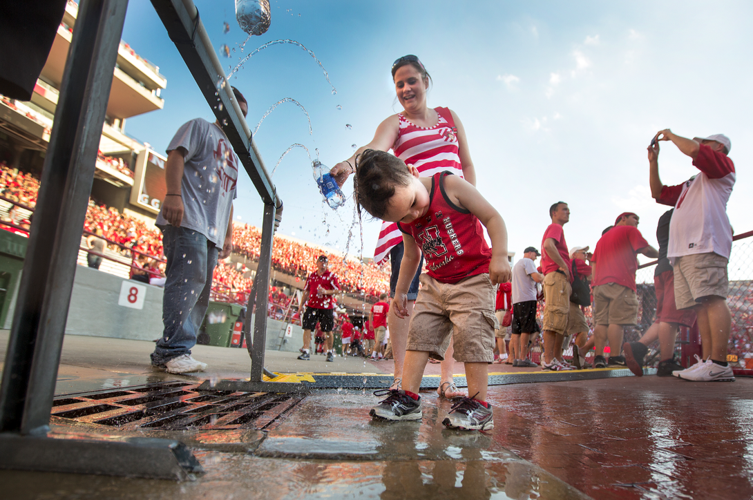 A young fan cools off during Nebraska's season opener Aug. 31 at Memorial Stadium. UNL officials are again urging fans attending this week's game to guard against heat illness.