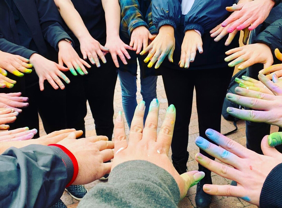 Sandra Williams (center, front) and students students showcased their paint-covered fingers after finishing the Havelock Avenue mural.