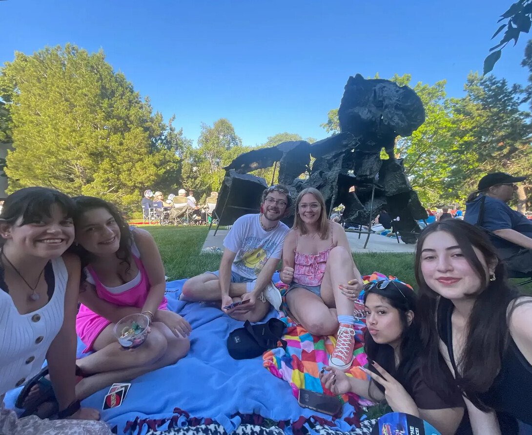 Students seated outside during a Jazz in June concert.