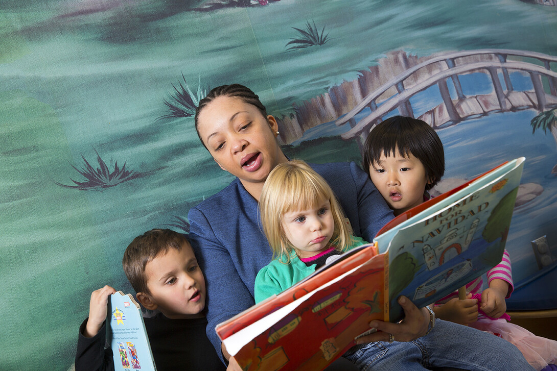 Tonia Durden reads to children and student teachers at UNL's Ruth Staples Center. The assistant professor was honored by the USDA for her contributions in family life and human development.